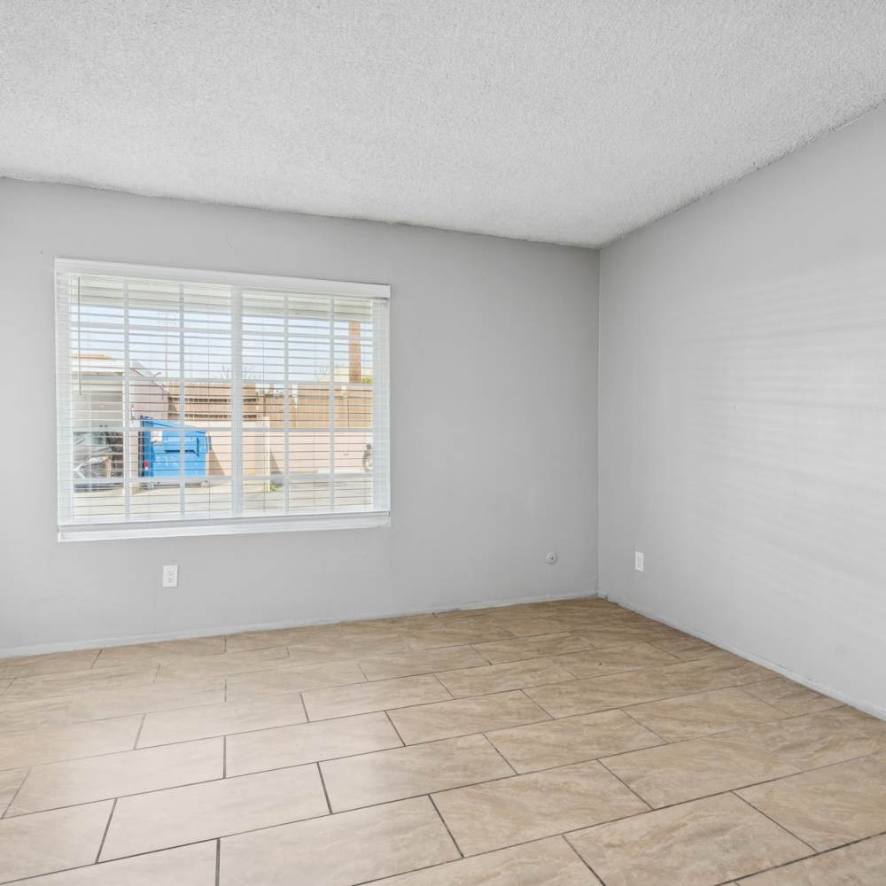 Bedroom with window at Newland Garden Apartments in Garden Grove, California