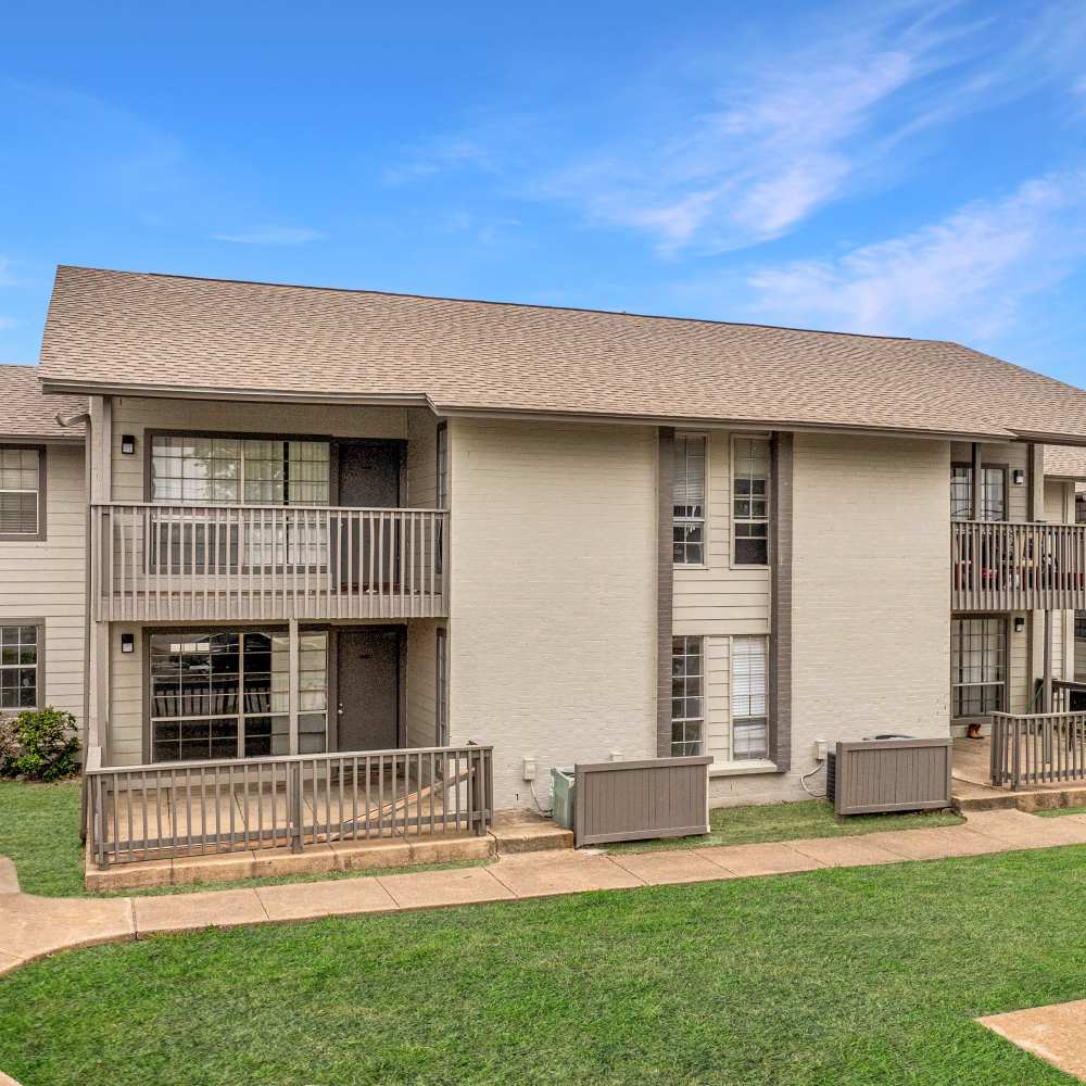 Charming community surrounded by lush greenery and inviting parking at Woodlands of Plano in Plano, Texas