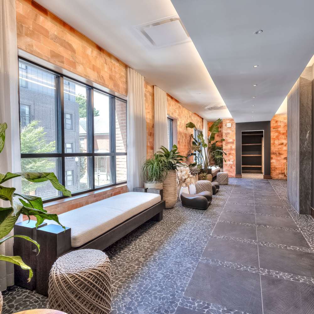 Stylish foyer with natural light and lush plants at Green|House Columbus in Columbus, Ohio