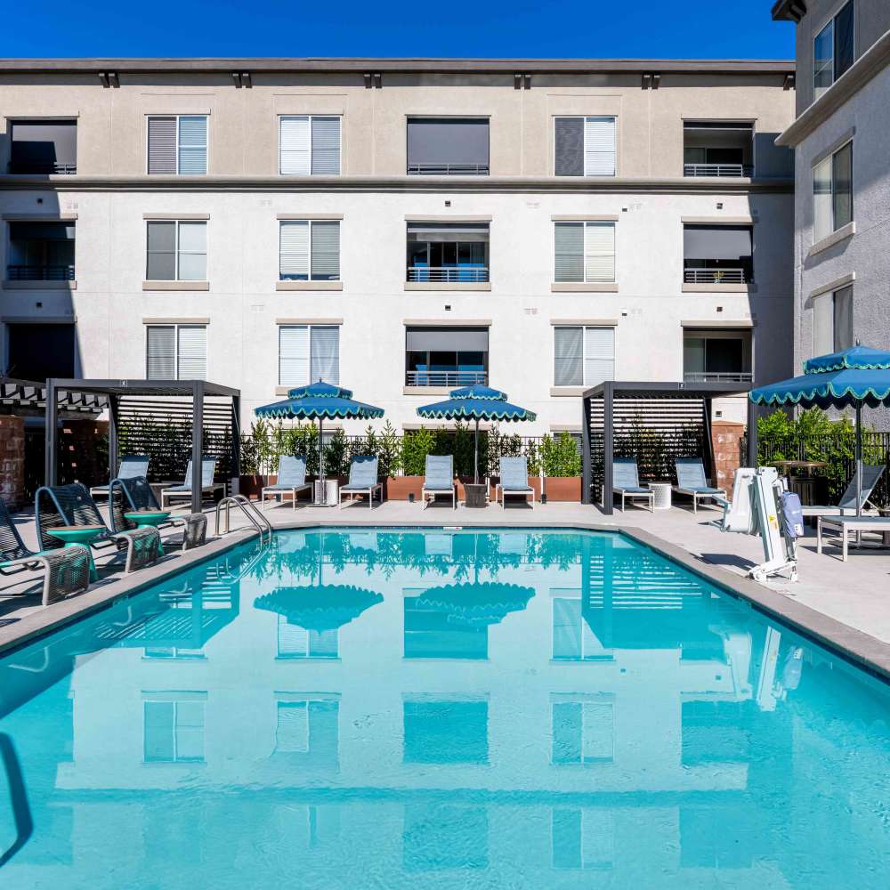 Pool with cabanas and lounge chairs