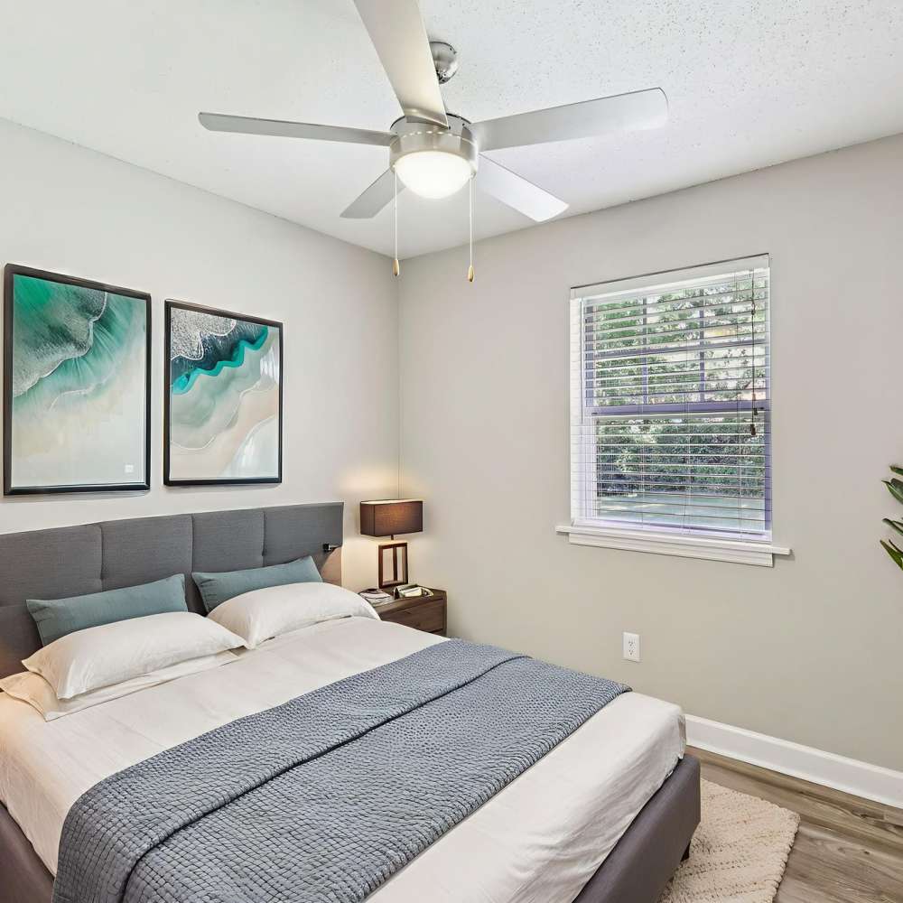 Stylish bedroom with wood-style flooring at The Ashley in Columbia,Tennessee