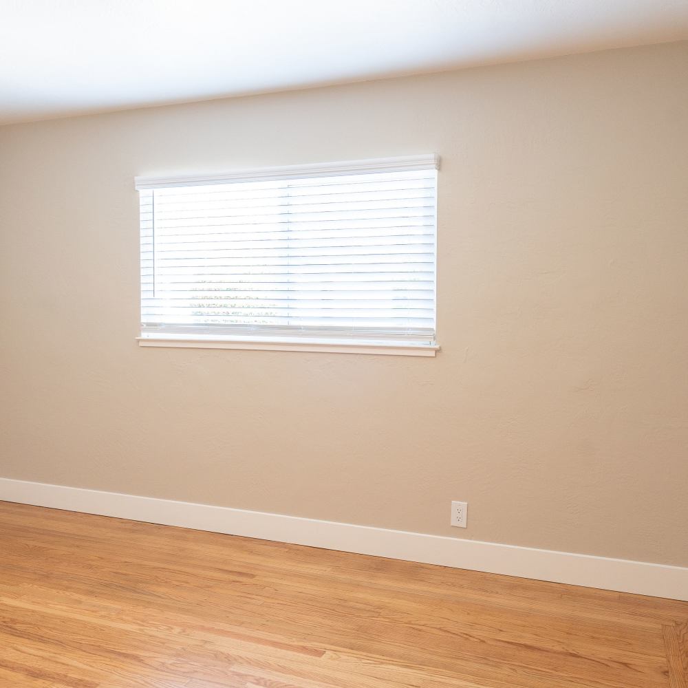 A bedroom with wood-style flooring at Garden Place in Hayward, California