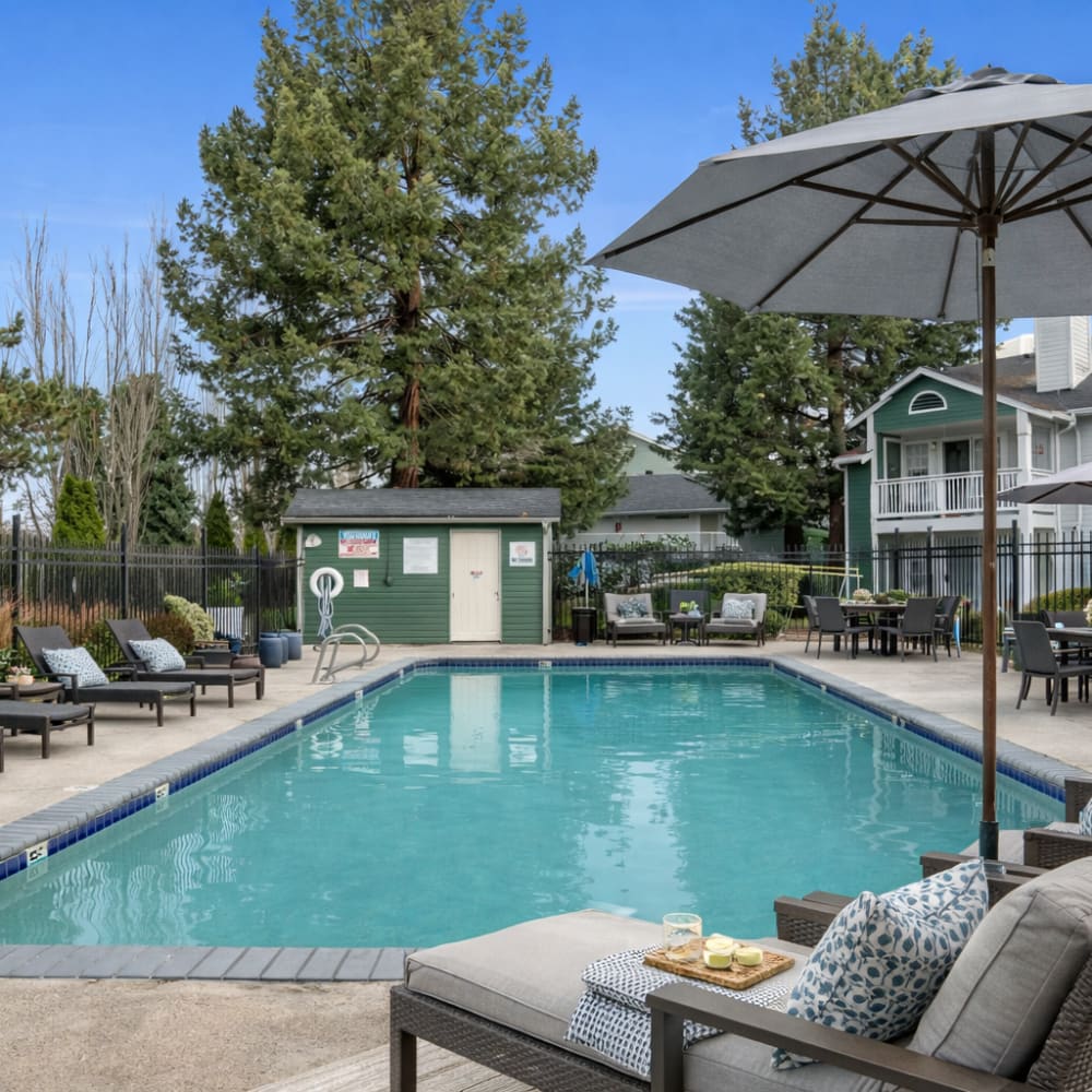 A couple sits by an outdoor fireplace, sharing a warm moment at Terravista in Tacoma, Washington