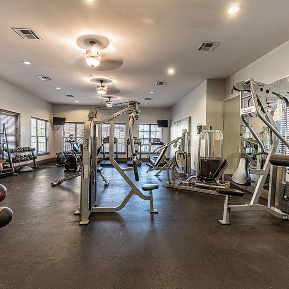 Spacious gym with modern equipment and bright natural light at Blue Ridge in Midland, Texas