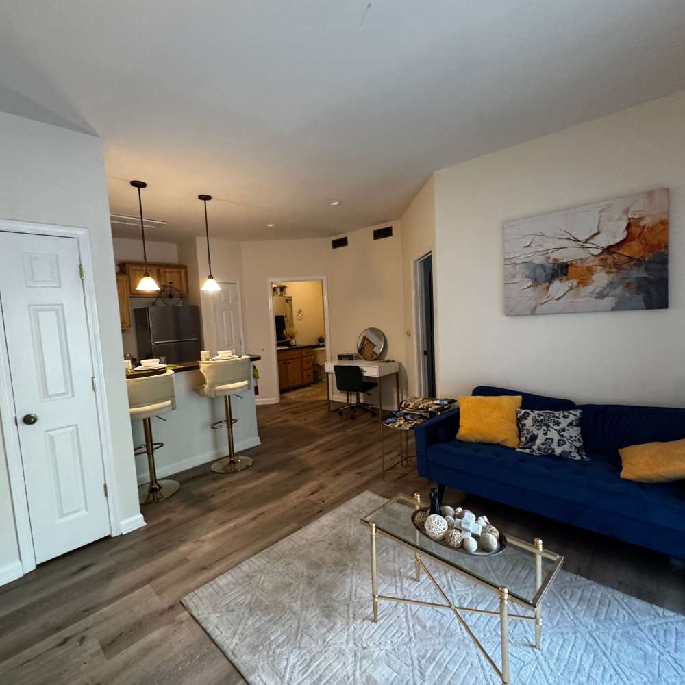Well-lit living room with a ceiling fan at Forest Ridge in Bloomington, Indiana