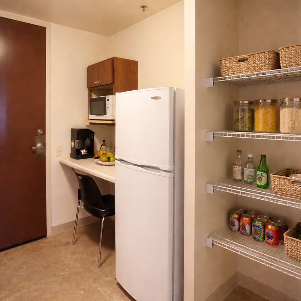 Cozy kitchen with white countertop at Council Tower Apartments in Saint Louis,Missouri