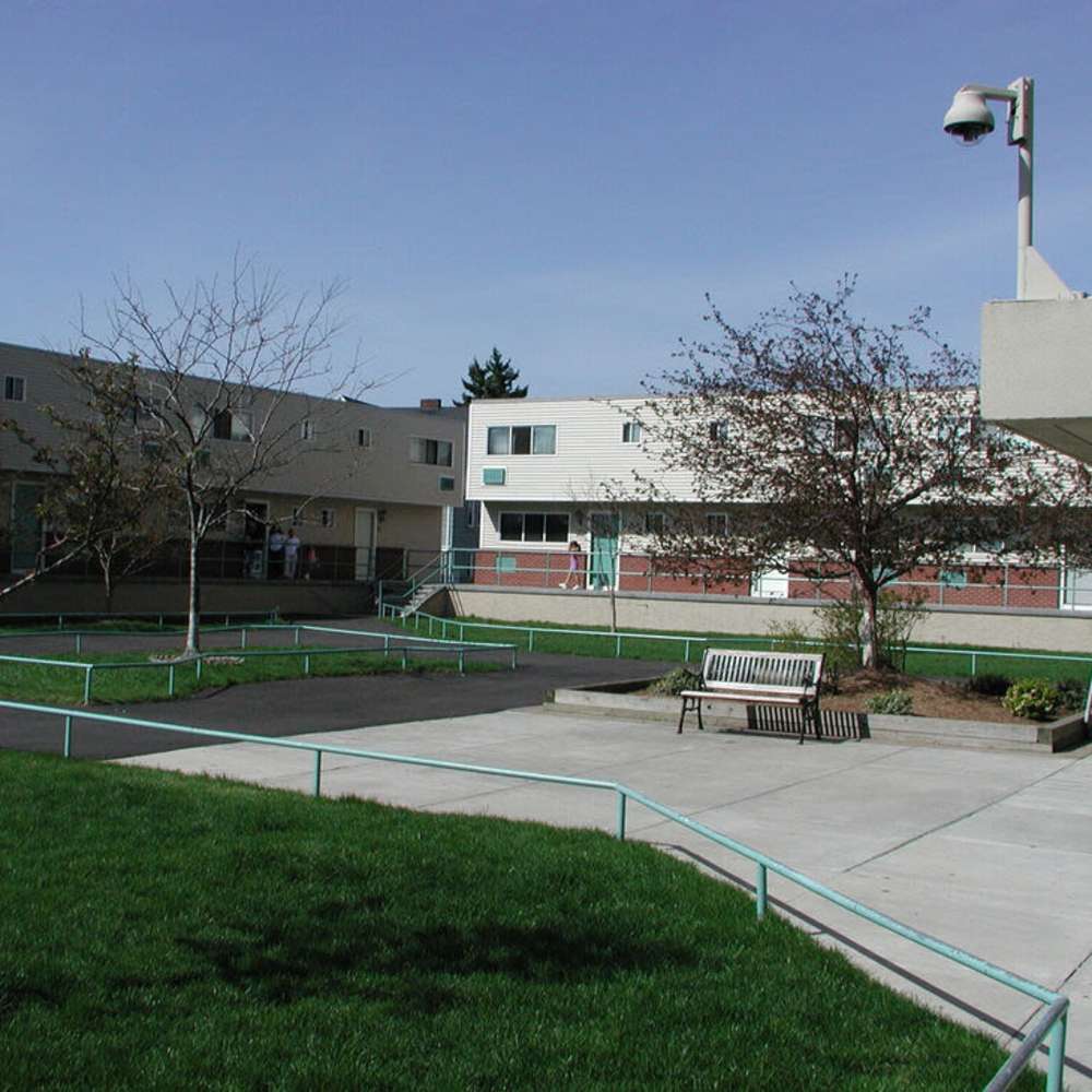 Community courtyard with benches at Los Flamboyanes in Rochester, New York