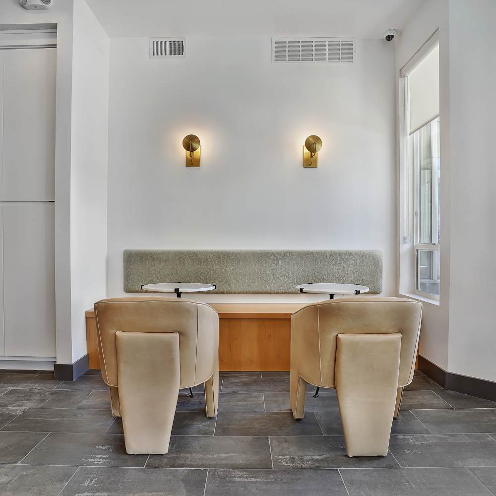 Modern seating area with stylish chairs and a cozy bench against a bright wall at Canyon View Crossing in Orem, Utah