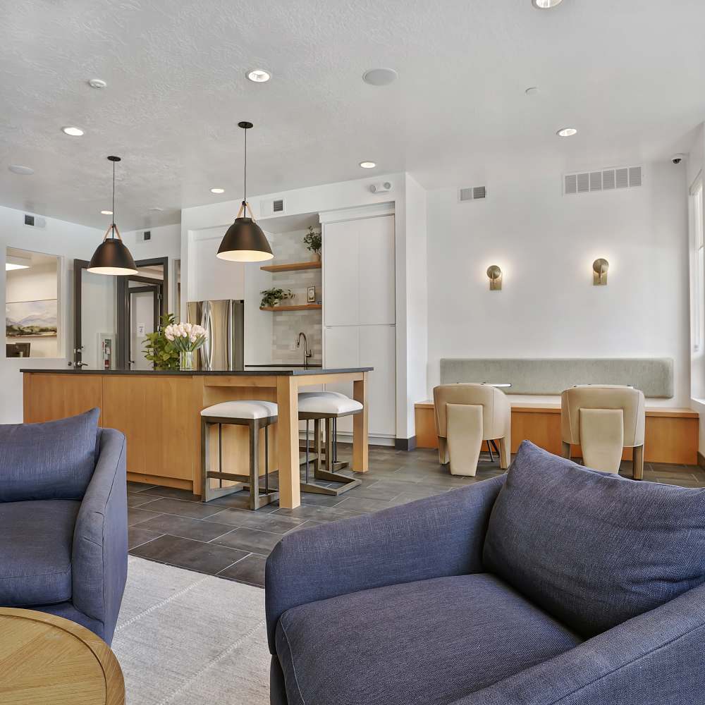 Modern kitchen with granite countertops, stainless steel appliances, and stylish pendant lights in open layout at Canyon View Crossing in Orem, Utah