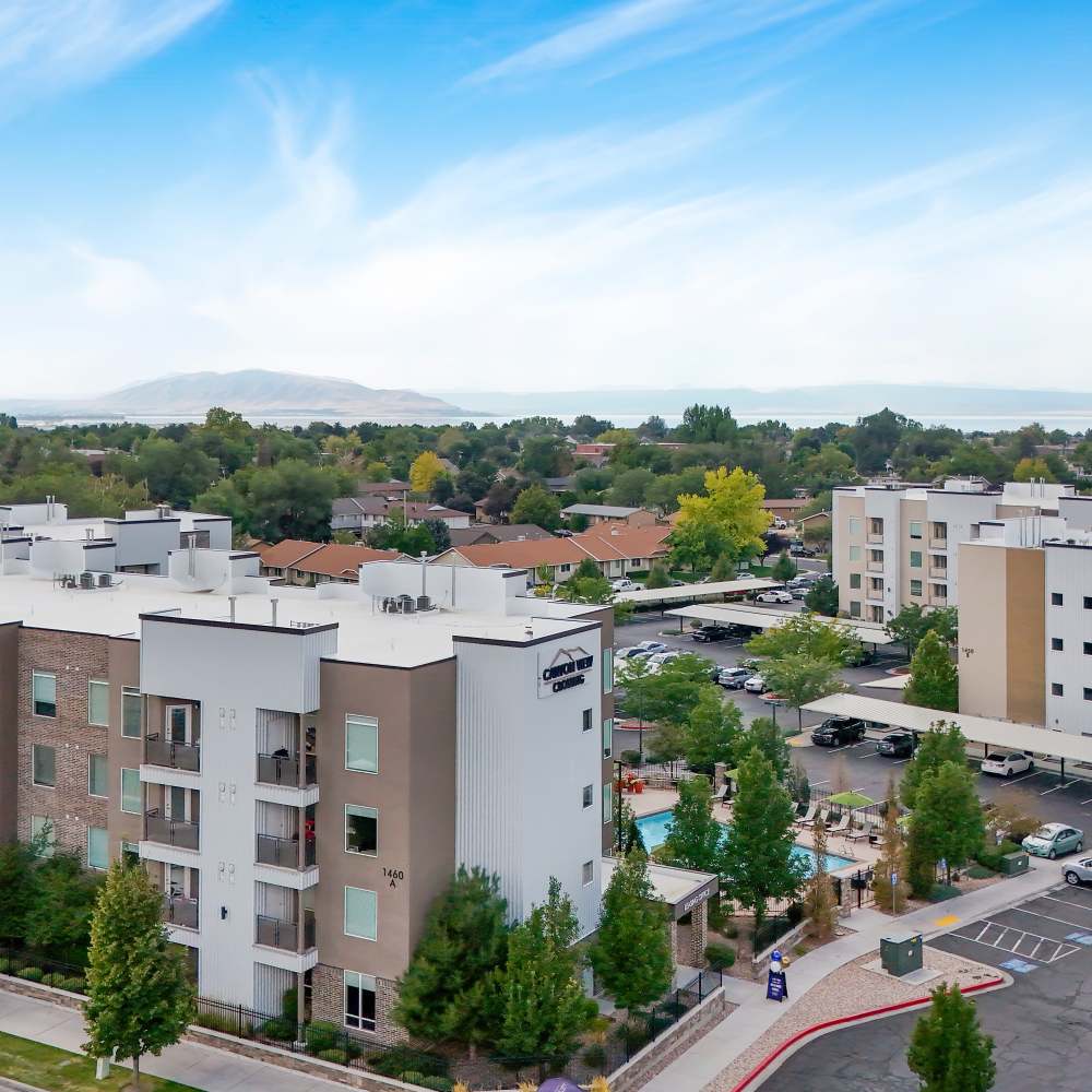 Aerial view of apartment community with resort-style pool and landscaped grounds at Canyon View Crossing in Orem, Utah