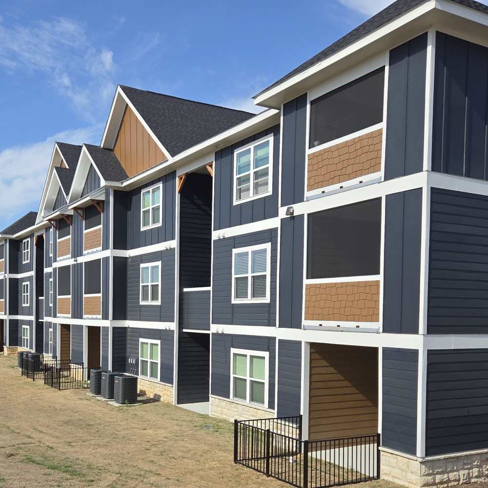 Building Exterior with fenced yard at Solstice Apartments in Madison, Alabama 