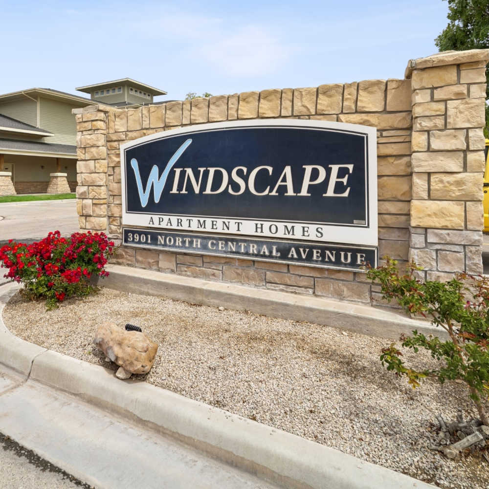 Monument sign with front office in background at Windscape Apartments in Hobbs, New Mexico