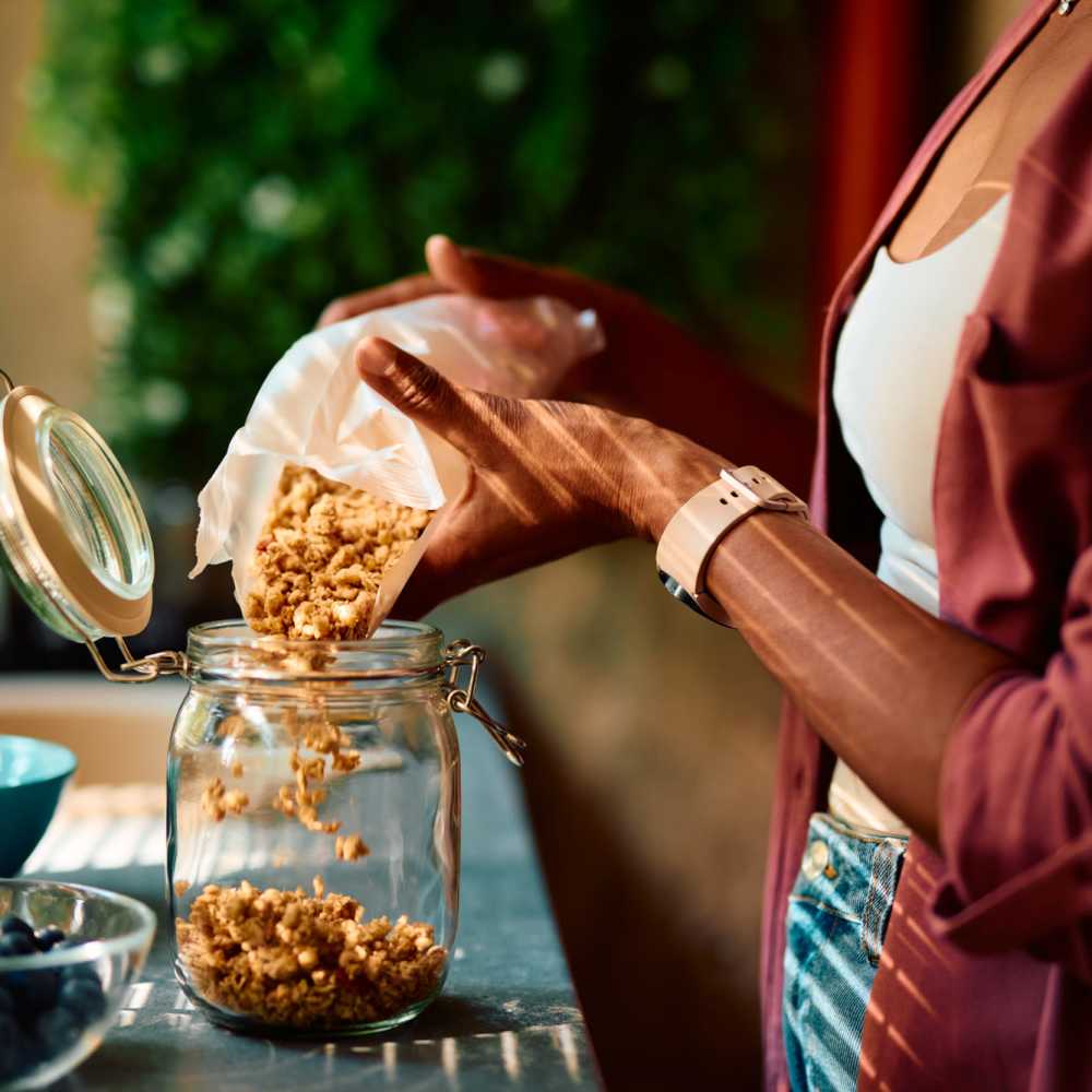 Woman pouring granola into a jar at NorthPark Apartment Homes in Gainesville, Texas