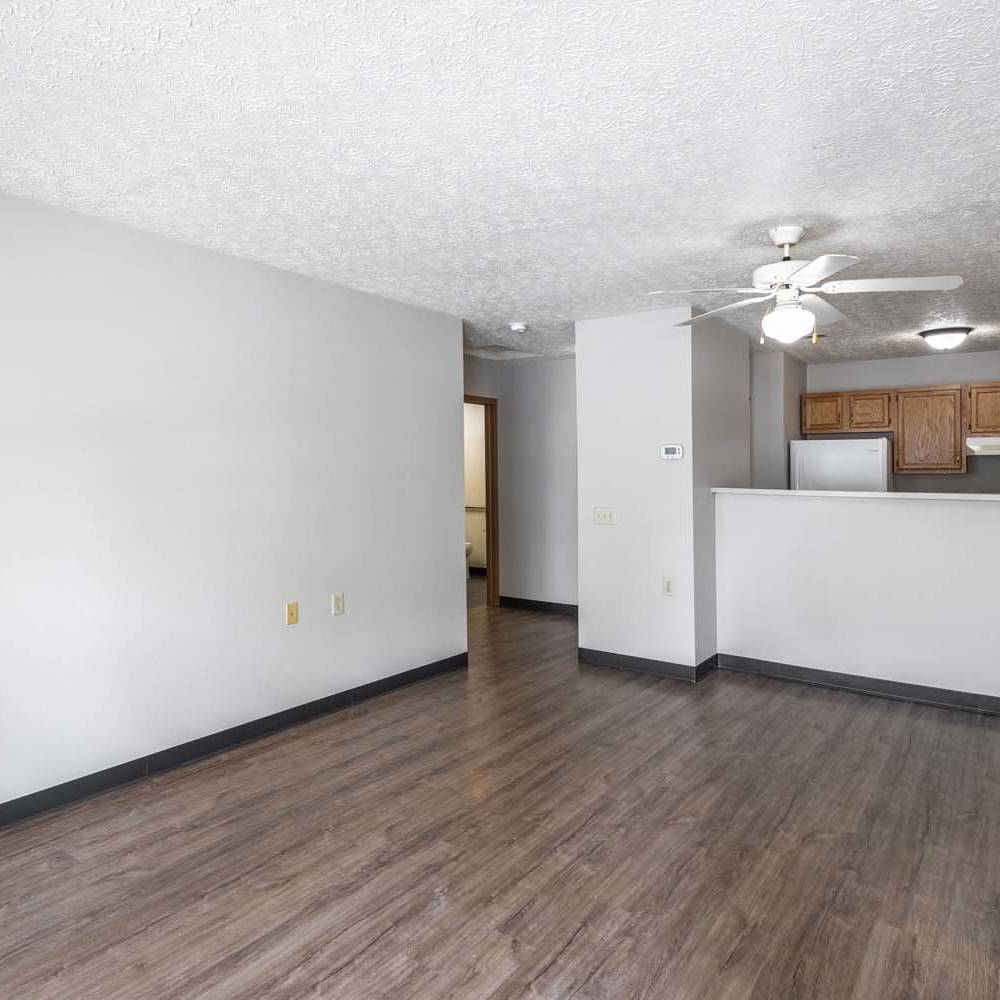 Open layout with wood-style flooring at Essex Place North in Sycamore, Ohio