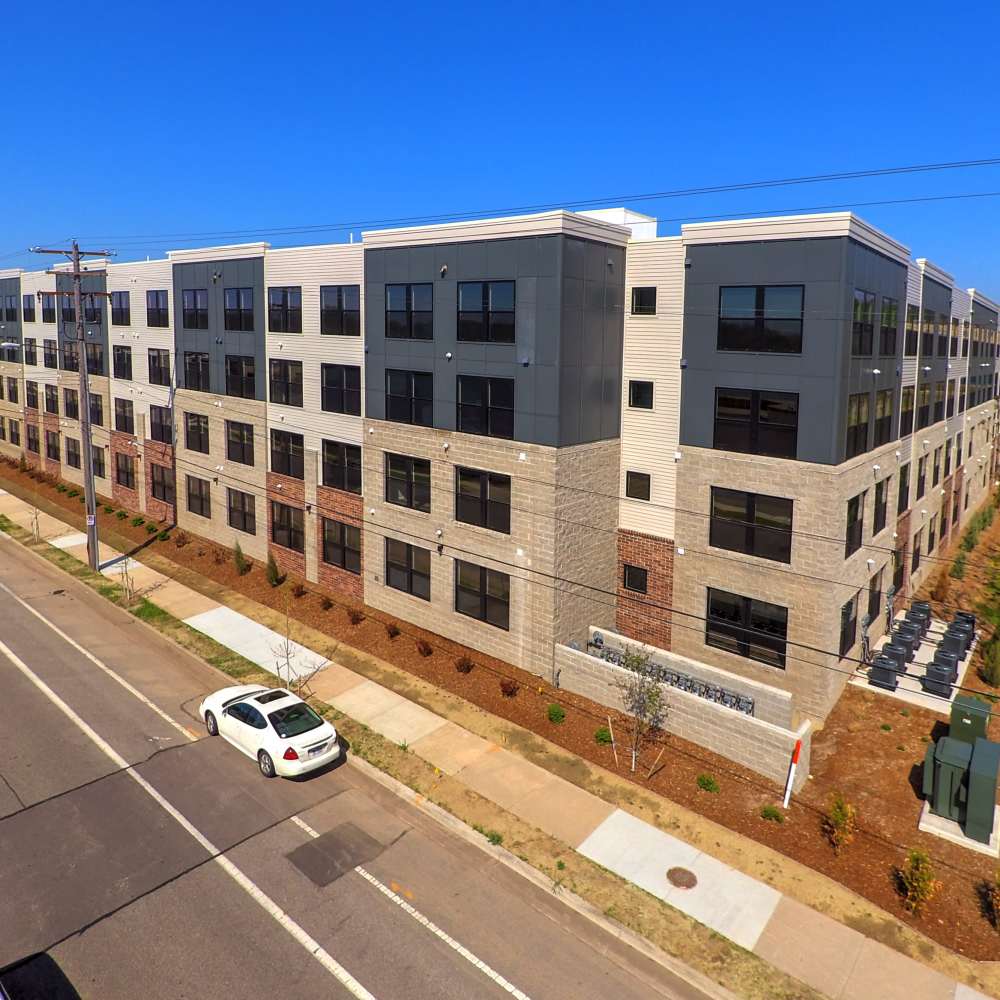 Modern apartment community with multiple stories, large windows, and landscaped grounds at Grand View Place in Grand Rapids, Michigan
