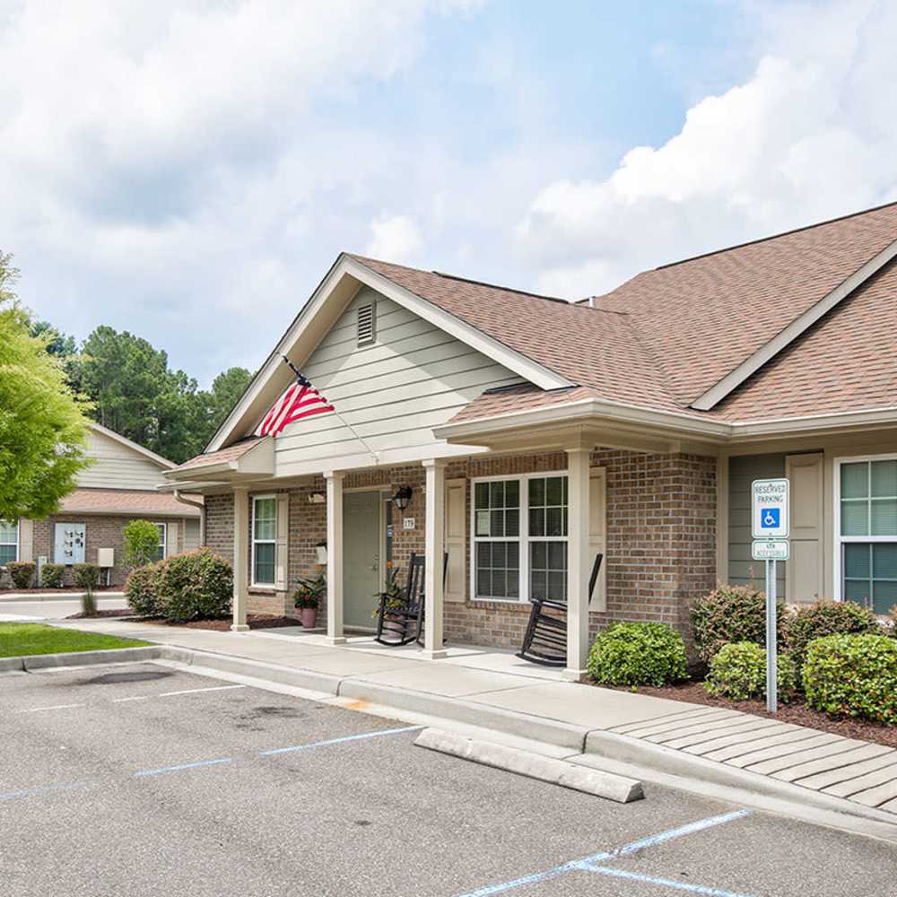 Clubhouse entrance with rocking chairs and American flag at Crowfield Greene in Goose Creek, South Carolina