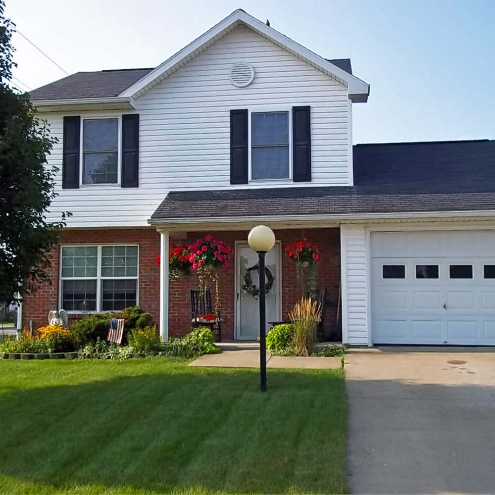 Front exterior of house with landscaped yard at Leewood Place in Fremont, Ohio