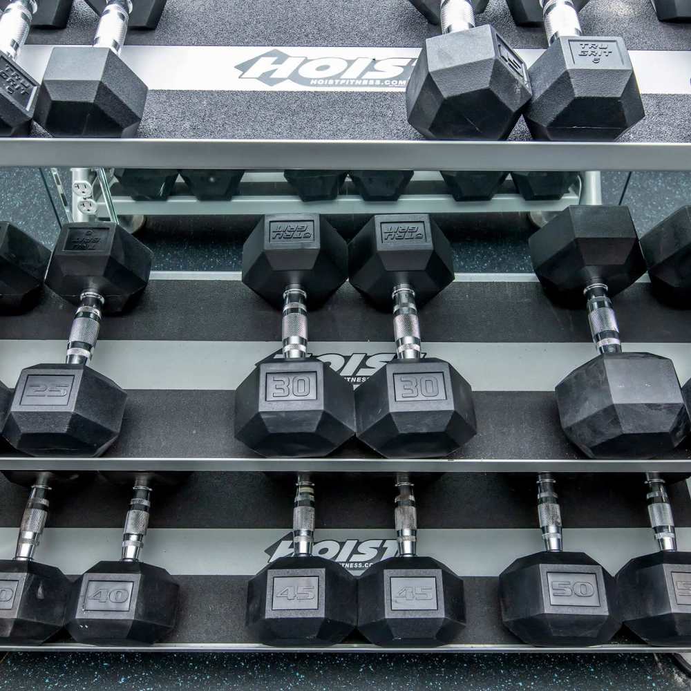 Dumbbells of various weights neatly arranged on a rack in a fitness center at The Arcadia in Madison, Tennessee