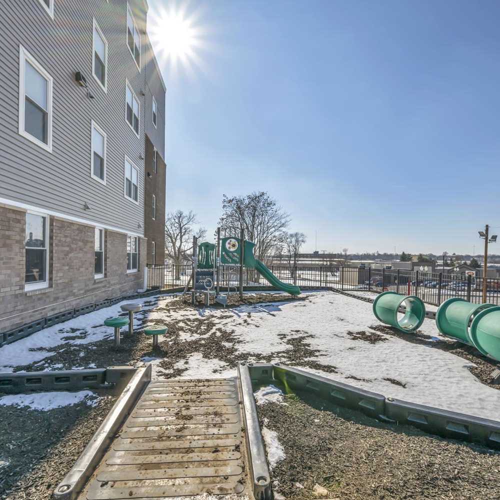 Playground equipment with slides at community park near Newton Family Apartments in Canton, Ohio