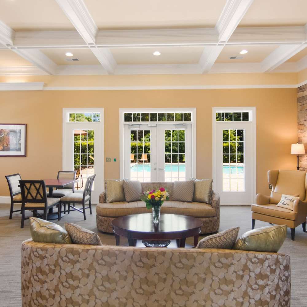 Clubhouse lounge with seating and pool view at Waverly Place in Louisa, Virginia