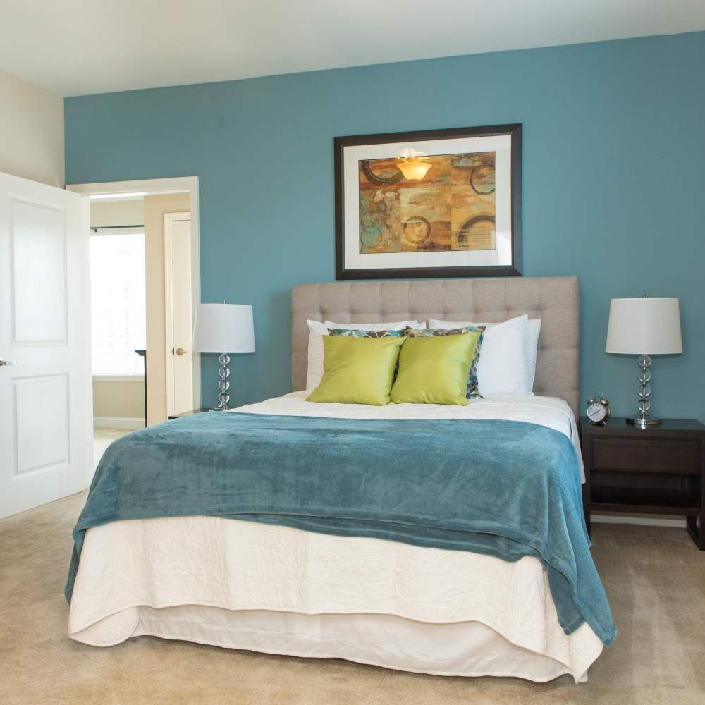 Bedroom with wall art  at The Apartments at Goose Creek in Fishersville, Virginia