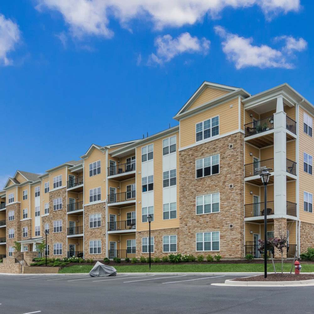 Community exterior view with parking area at The Apartments at Goose Creek in Fishersville, Virginia