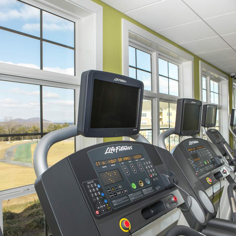 Treadmills in fitness center at The Apartments at Goose Creek in Fishersville, Virginia