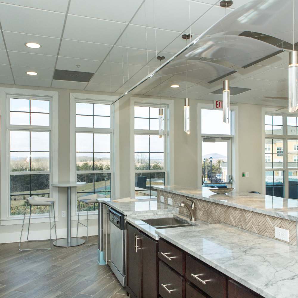Clubhouse kitchen with raised countertop  at The Apartments at Goose Creek in Fishersville, Virginia
