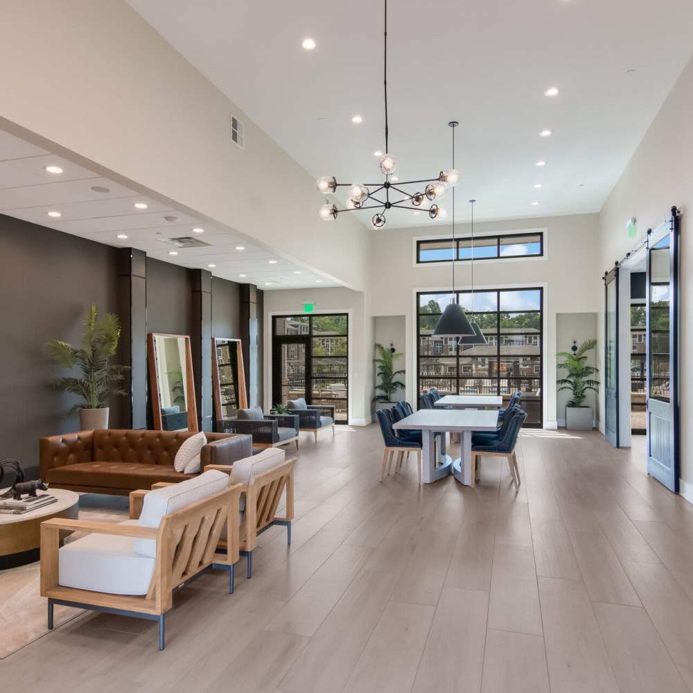 Spacious clubhouse with seating space, hanging light and large windows at The Knoll at Stone View in Ruckersville, Virginia