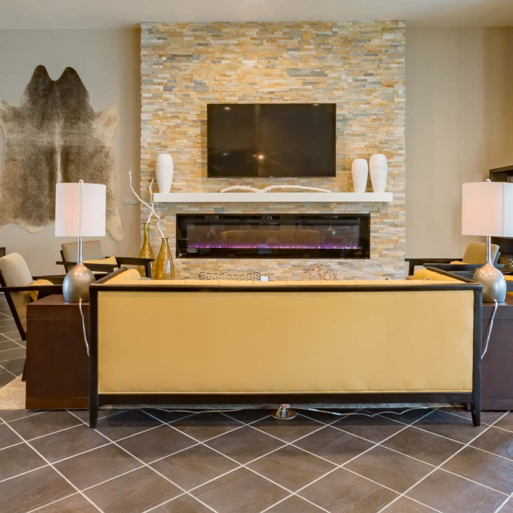 Modern lounge with fireplace and TV at Stonegate at the Crossroads in Zion Crossroads, Virginia