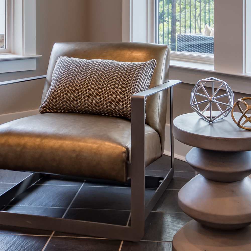 Modern chair with decorative pillow at Stonegate at the Crossroads in Zion Crossroads, Virginia