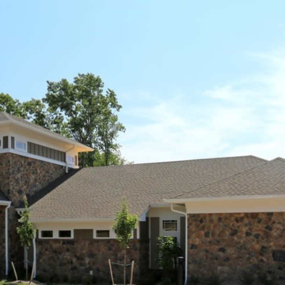 Stone exterior home with landscaped yard at Stonegate at the Crossroads in Zion Crossroads, Virginia