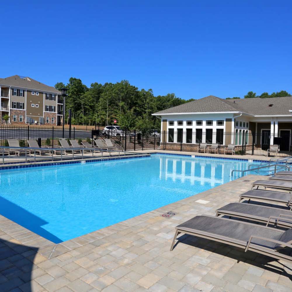 Resort-style pool with lounge chairs at Stonegate at the Crossroads in Zion Crossroads, Virginia