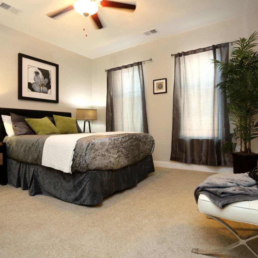 Cozy bedroom with carpeted flooring at Stonegate at the Crossroads in Zion Crossroads, Virginia