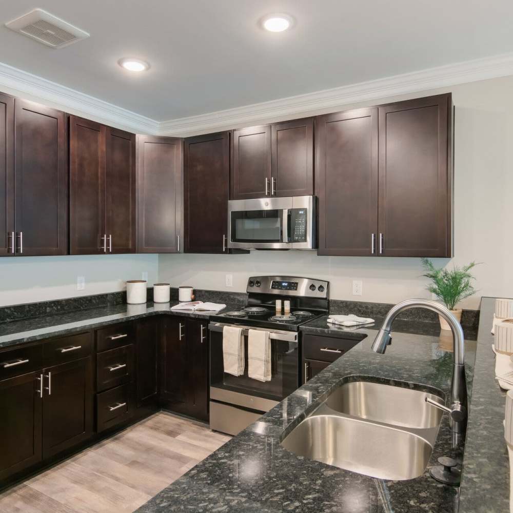 Kitchen with granite countertop  at The Apartments At Kelton Station in Williamsburg, Virginia