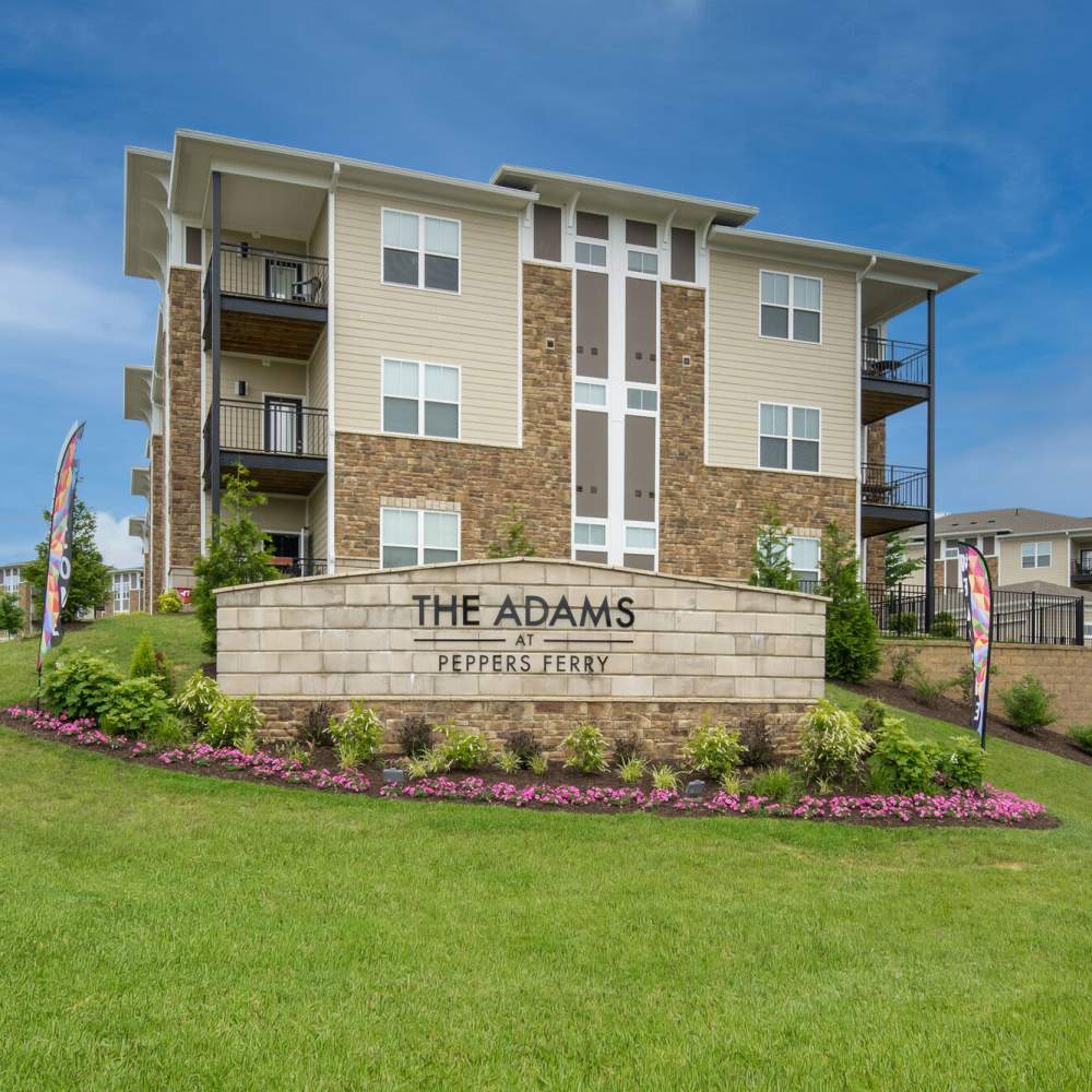 Community sign board and apartment at The Adams at Peppers Ferry in , Virginia