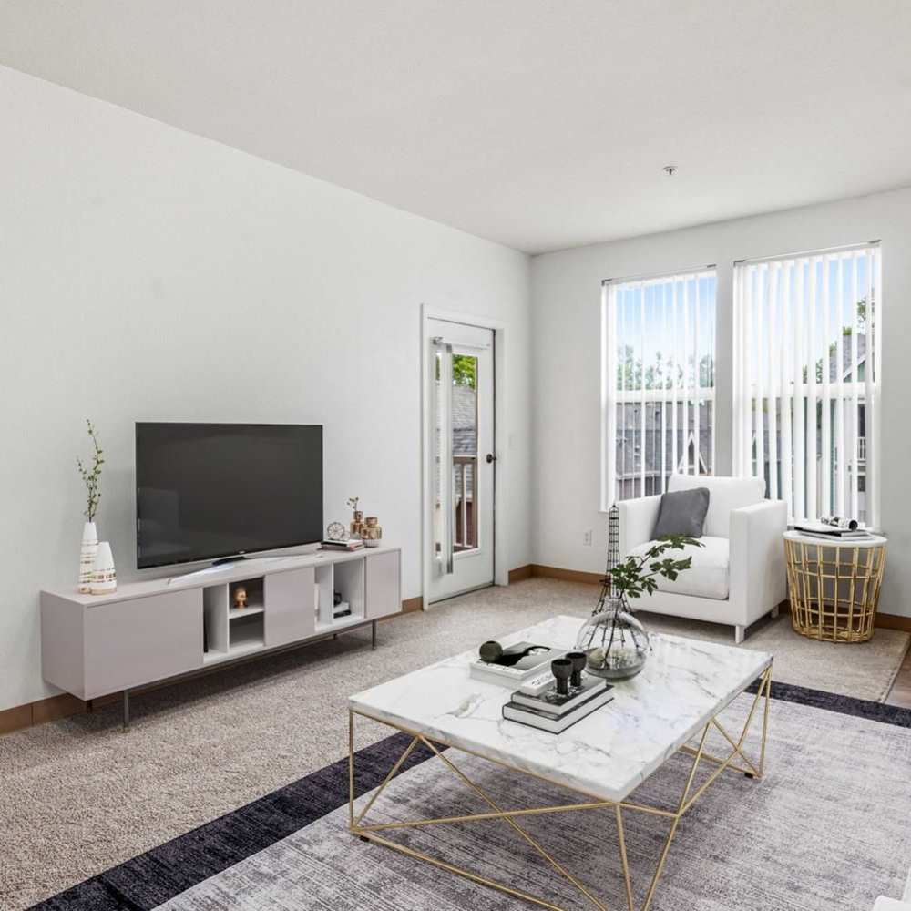Living room with tv console coffee table and sliding glass door at Market Gateway in San Jose, California