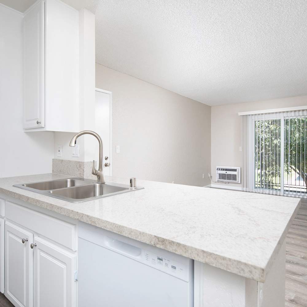 Granite countertops with stainless steel appliances at Wexford Manor Apartments in San Diego, California