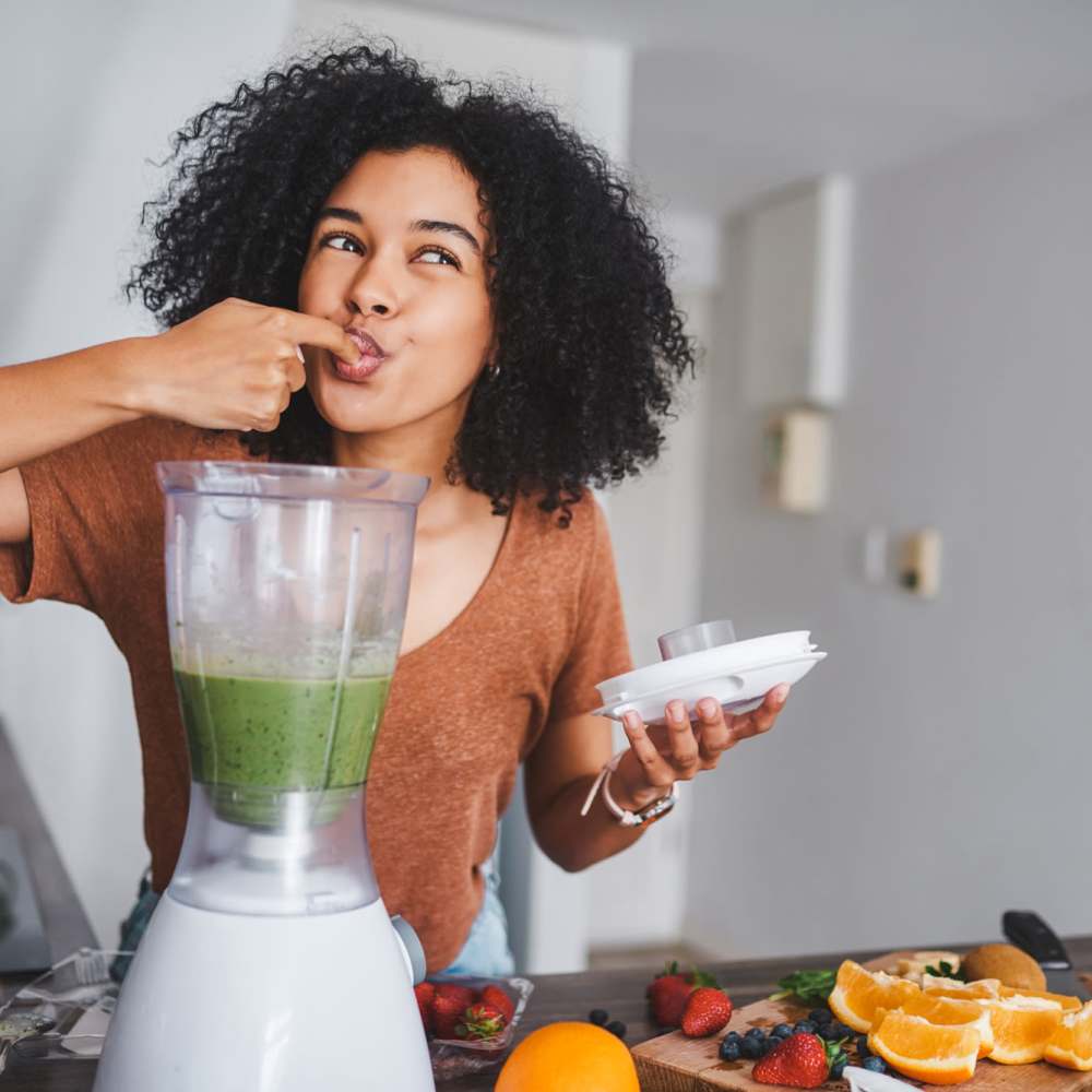 Resident making a smoothie in her apartment at Grand Oak Apartments in Largo, Florida