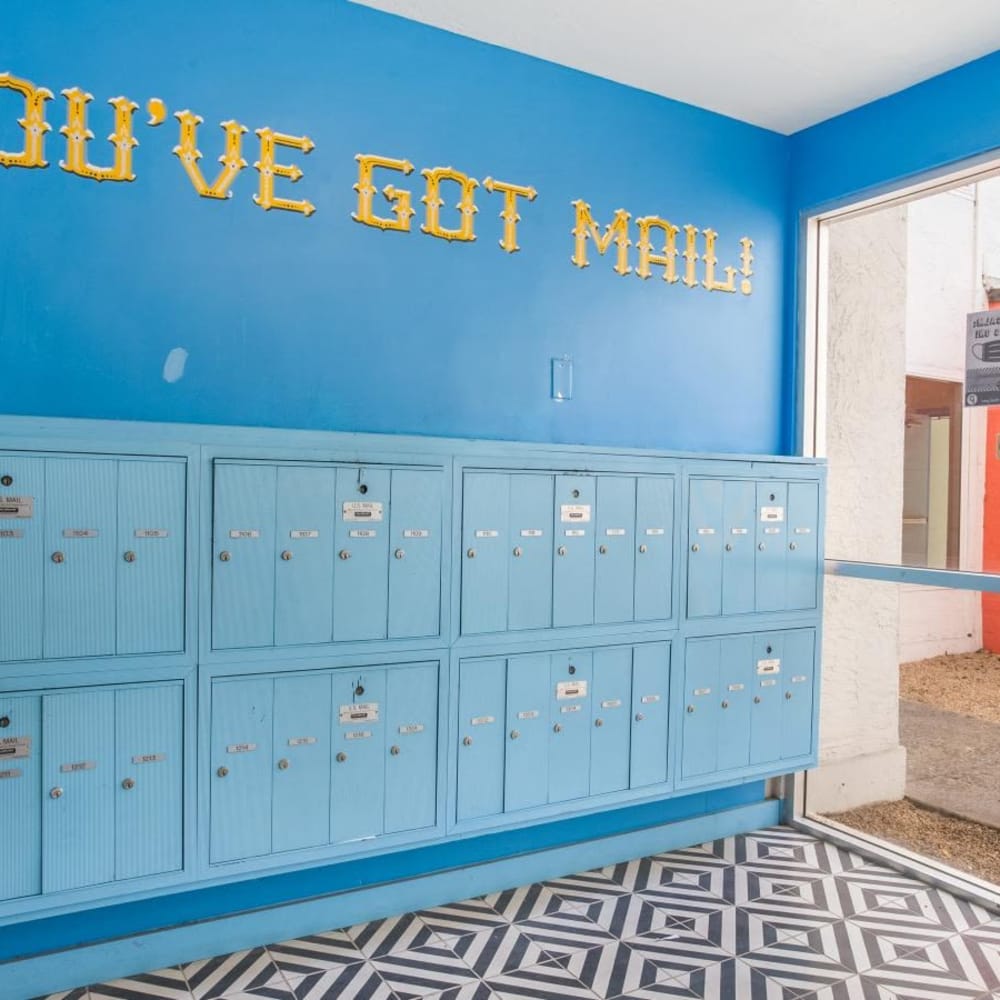 Bright blue mailboxes with patterned flooring at Tempo Fremont in Fremont, California