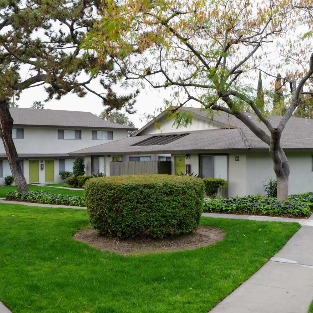 Lush landscaping with pathways at Terramonte Apartment Homes in Pomona, California