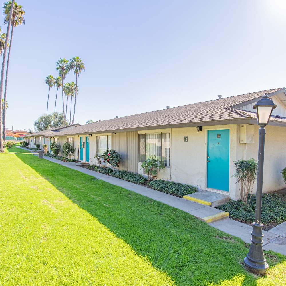 Apartment units with vibrant blue doors at Terramonte Apartment Homes in Pomona, California