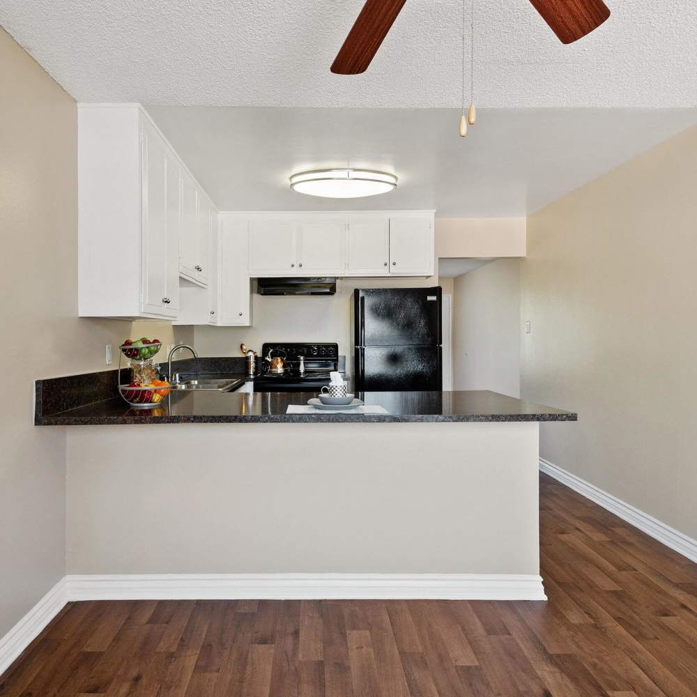 Granite countertops in modern kitchen at Terramonte Apartment Homes in Pomona, California