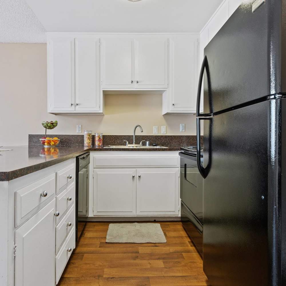 Bright kitchen with granite countertops at Terramonte Apartment Homes in Pomona, California