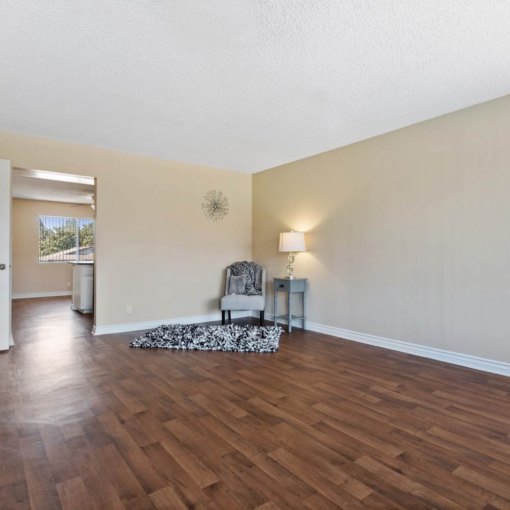 Open layout with wood-style flooring at Terramonte Apartment Homes in Pomona, California