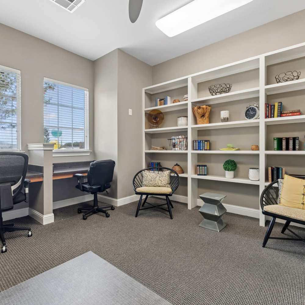 Office with desk, shelves, and seating at Point Royale Apartments in Victoria, Texas