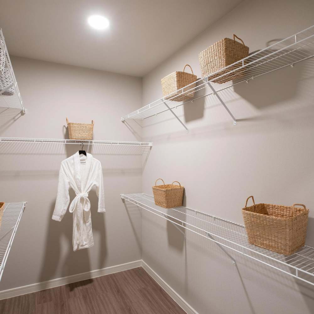 Spacious walk-in closet with organized storage at August Friendswood in Friendswood, Texas