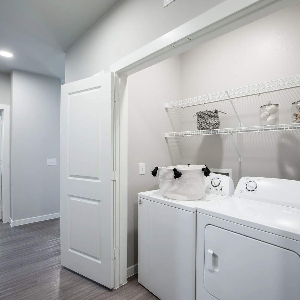 Laundry area with washer and dryer at August Friendswood in Friendswood, Texas