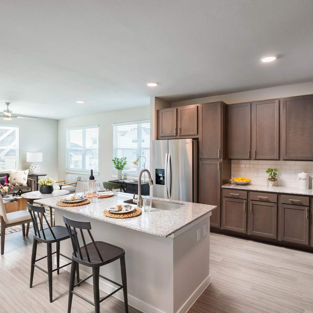 Granite countertops with bar seating at kitchen August Friendswood in Friendswood, Texas
