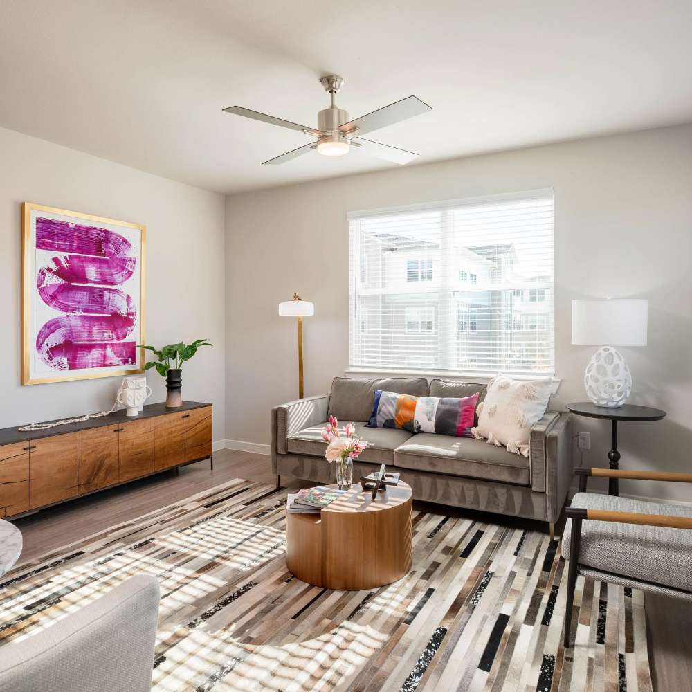 Stylish wood-style flooring in modern living room at August Friendswood in Friendswood, Texas